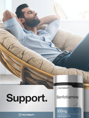 View 6 An adult man is relaxing with eyes closed, hands behind his head, next to a Benfotiamine supplement bottle.