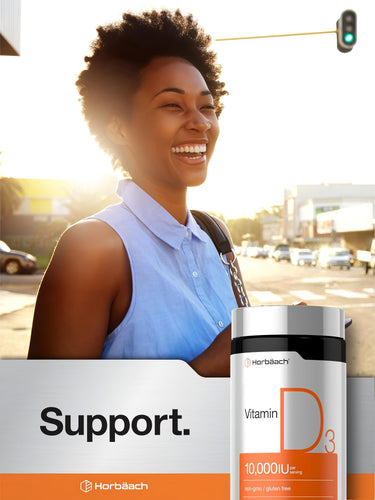 View 6 A young Black woman is laughing outdoors while holding a Horbäach Vitamin D 10,000 IU bottle.