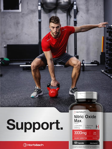 View 6 Young adult male squatting with a kettlebell in a gym, with a Horbaach Nitric Oxide Max bottle in the foreground.