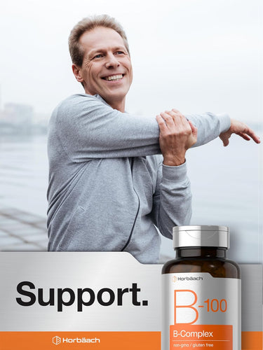 Man stretching with a bottle of B-100 B-Complex supplement in the foreground