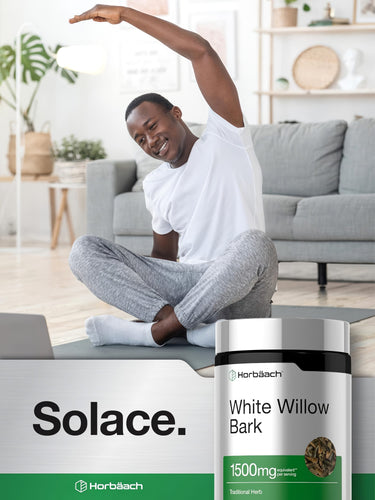 View 6 Young Black male stretches on yoga mat with Horbäach White Willow Bark bottle beside him.