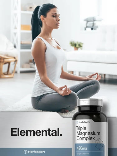 Woman meditating with a bottle of Elemental Triple Magnesium Complex supplement in the foreground.