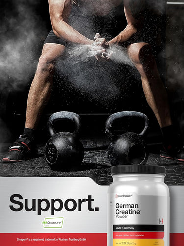 Person applying powder to hands with kettlebells, Hertlich German Creatine Powder container displayed.