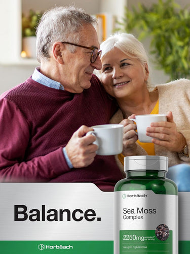 Couple holding cups with a bottle of Horbaach Sea Moss Complex in the foreground.