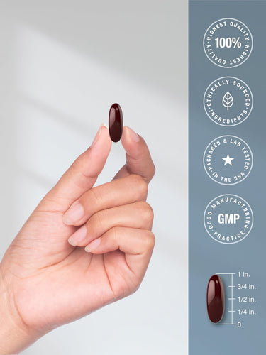 View 7 A 1-inch dark red Magnesium Citrate 850mg softgel held in a hand.