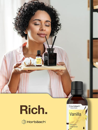 Woman holding a tray with vanilla-scented products and Horbaach Vanilla fragrance bottle.