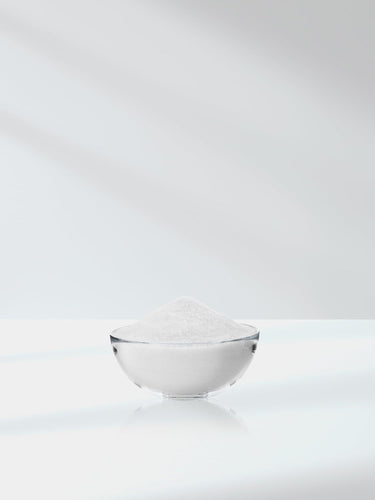 White bowl filled with white powder on a white background