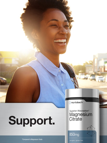 View 8 Smiling Black woman walking outdoors holding a Horbäach Magnesium Citrate bottle.