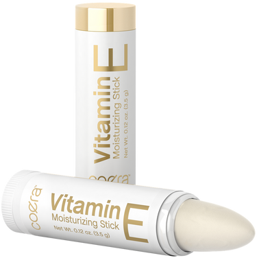Two Vitamin E moisturizing sticks with gold accents on a white background