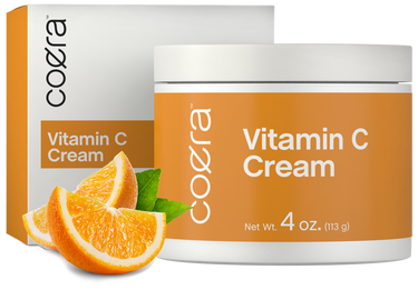 View 1 Coera Vitamin C Cream jar and packaging with oranges on a white background