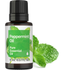 Peppermint essential oil bottle with green label and mint leaves on a white background