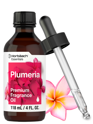 View 1 Plumeria fragrance oil bottle with dropper and plumeria flower on a white background