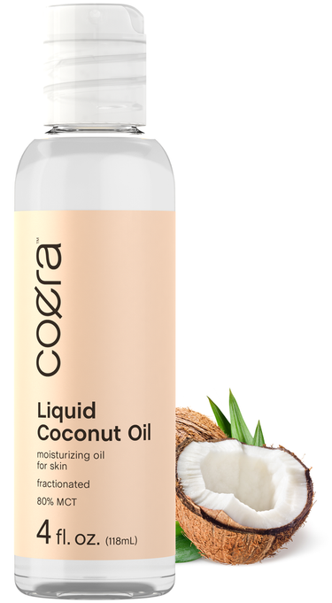 Bottle of Coera Liquid Coconut Oil with a coconut and leaves on a white background