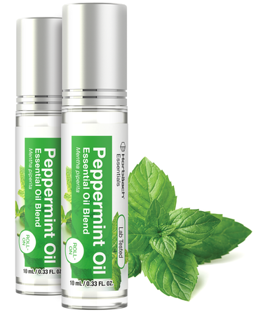 View 1 Two bottles of peppermint oil with green labels and mint leaves on a white background