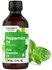 Bottle of peppermint essential oil with leaves on a white background