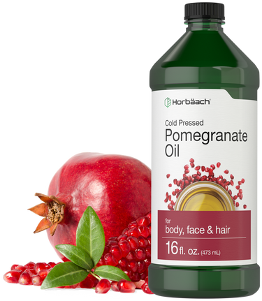 Horbaach Pomegranate Oil bottle with pomegranate fruit and seeds on a white background