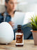 Bottle of Musk premium fragrance oil next to a diffuser on a table with a blurred person in the background.
