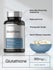 Glutathione supplement bottle with capsules on a gray background