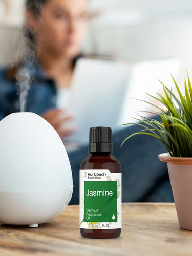 Bottle of Horbach Jasmine fragrance oil with a diffuser and plant on a table.
