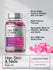 Bottle of Hair, Skin & Nails supplement with pink capsules and product features on a light background.