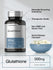 Glutathione supplement bottle with bowl of capsules and text labels.