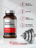 Bottle of creatine monohydrate capsules with nutritional information and a dumbbell.