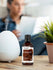 view 4 Bottle of coconut fragrance oil next to a diffuser on a table with a blurred background