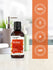 view 5 Bottle of amber premium fragrance oil with certification logos on an orange background.