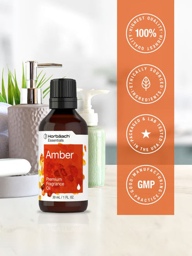 View 5 Bottle of amber premium fragrance oil with certification logos on an orange background.