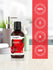 view 5 Bottle of apple fragrance oil with certification logos on a red background.