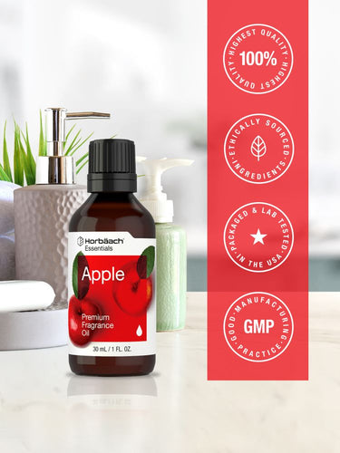 Bottle of apple fragrance oil with certification logos on a red background.
