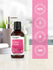 Bottle of fragrance oil with pink label on a white background with certification icons.