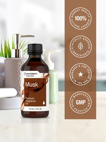 Bottle of Musk premium fragrance oil with branding and certification logos on a blurred background
