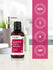 Harlech Essentials Japanese Cherry Blossom fragrance oil bottle with certification logos on a blurred background