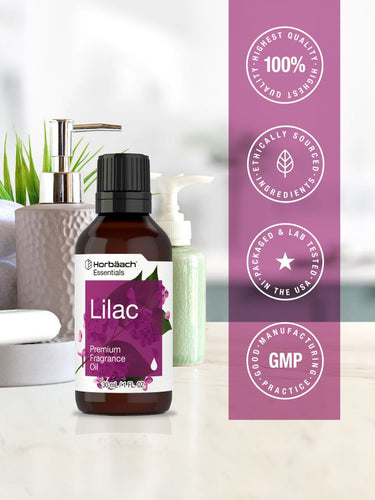 View 5 Bottle of lilac fragrance oil with purple label on a white background.