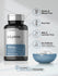 Bottle of L-Lysine supplements with a bowl of capsules on a light gray background