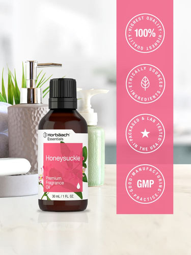 Honeysuckle essential oil bottle with pink label on a white surface, featuring Harborside Essentials branding.
