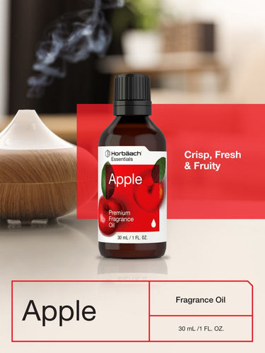 View 6 Bottle of apple fragrance oil with a diffuser and blurred background.