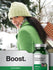 Woman in green coat and hat with a bottle of Echinacea and Goldenseal supplement.