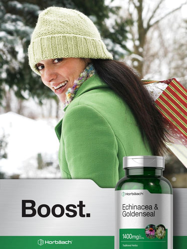 Woman in green coat and hat with a bottle of Echinacea and Goldenseal supplement.