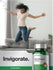 Person jumping on a couch with a bottle of mushroom complex supplement in the foreground.