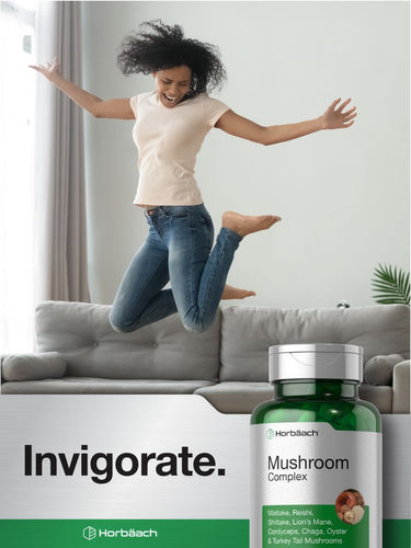 Person jumping on a couch with a bottle of mushroom complex supplement in the foreground.