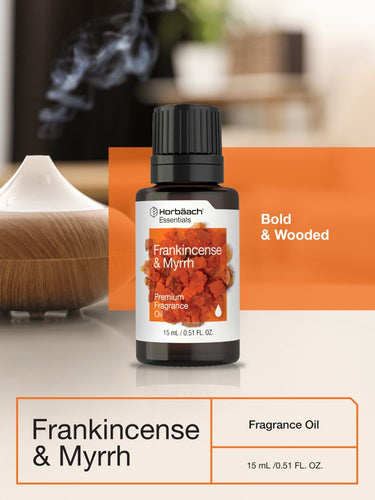 Bottle of Frankincense & Myrrh fragrance oil with a diffuser in the background