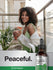 view 6 Woman holding a glass with a bottle of Horbaach peppermint leaf extract on a 'Peaceful.' branded background