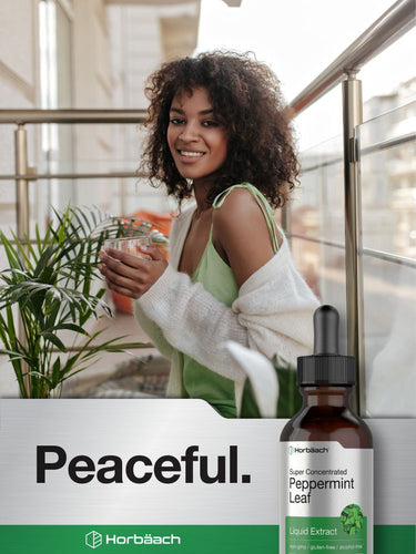 View 6 Woman holding a glass with a bottle of Horbaach peppermint leaf extract on a 'Peaceful.' branded background