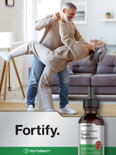 Couple dancing in a living room with a bottle of Fortify Horbaach Reishi Mushroom supplement in the foreground.