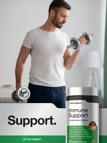 View 6 A hand holding a bottle of Horbäach Immune Support+ 10 Mushroom Blend, containing 60 vegetarian capsules.