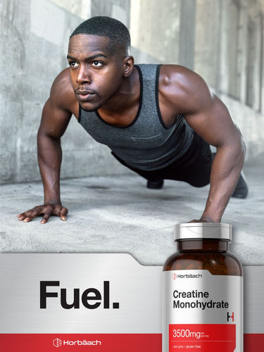 Man doing push-ups with a bottle of creatine monohydrate supplement in the foreground.