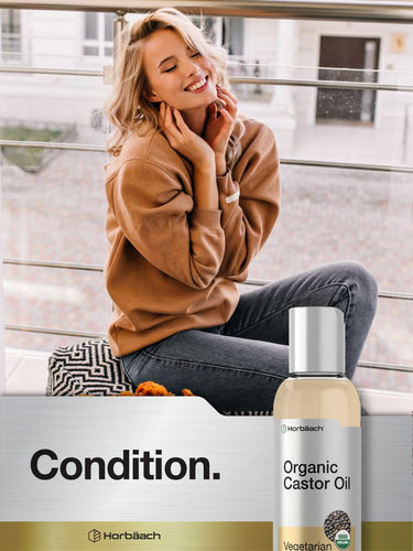 Woman applying oil to her neck with a bottle of Herbäch Organic Castor Oil in the foreground.