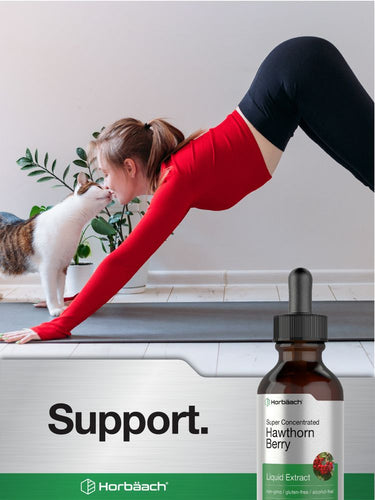 View 6 Woman stretching with a cat on a yoga mat, Horbaach Hawthorn Berry Liquid Extract bottle displayed.